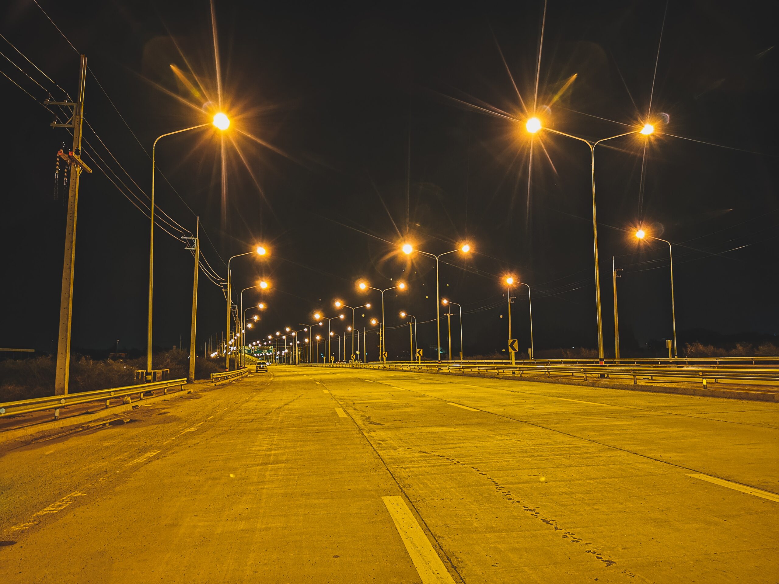 empty-road-against-illuminated-street-lights-city-night